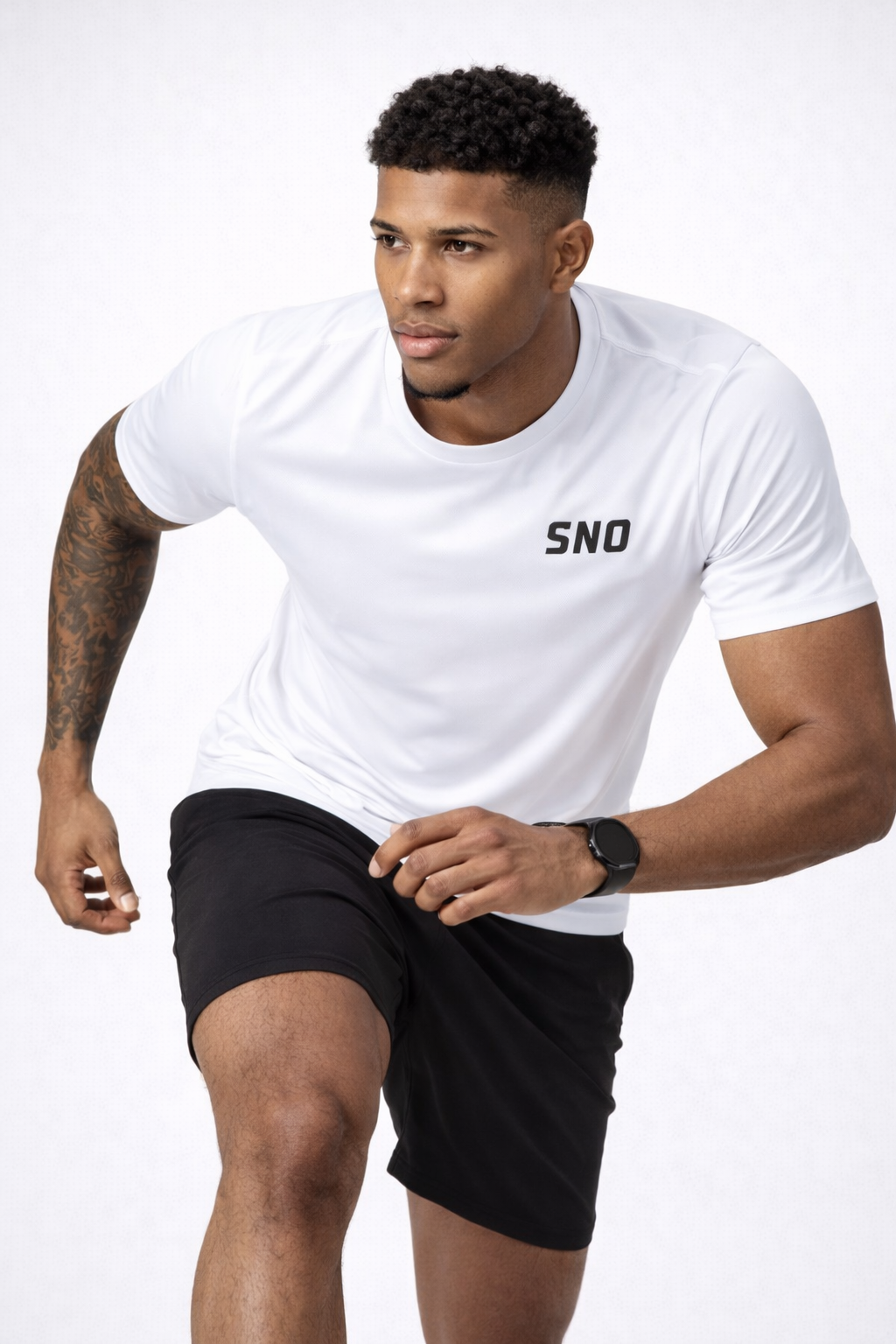 Man wearing a white t-shirt with 'SNO' logo and black shorts on a white background