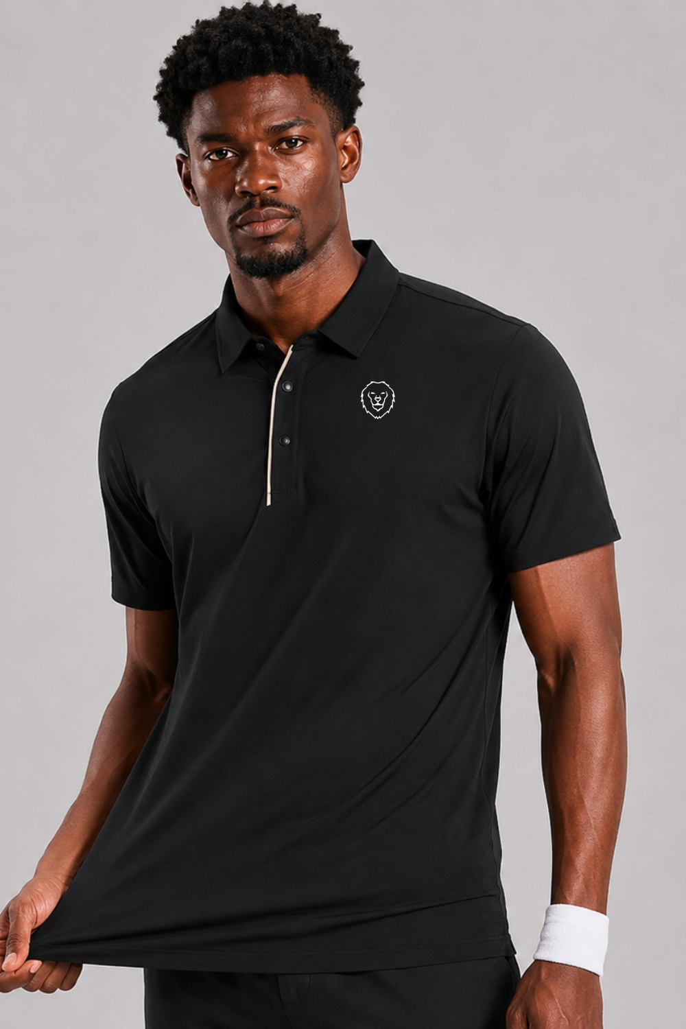 Man wearing a black polo shirt and black pants on a gray background