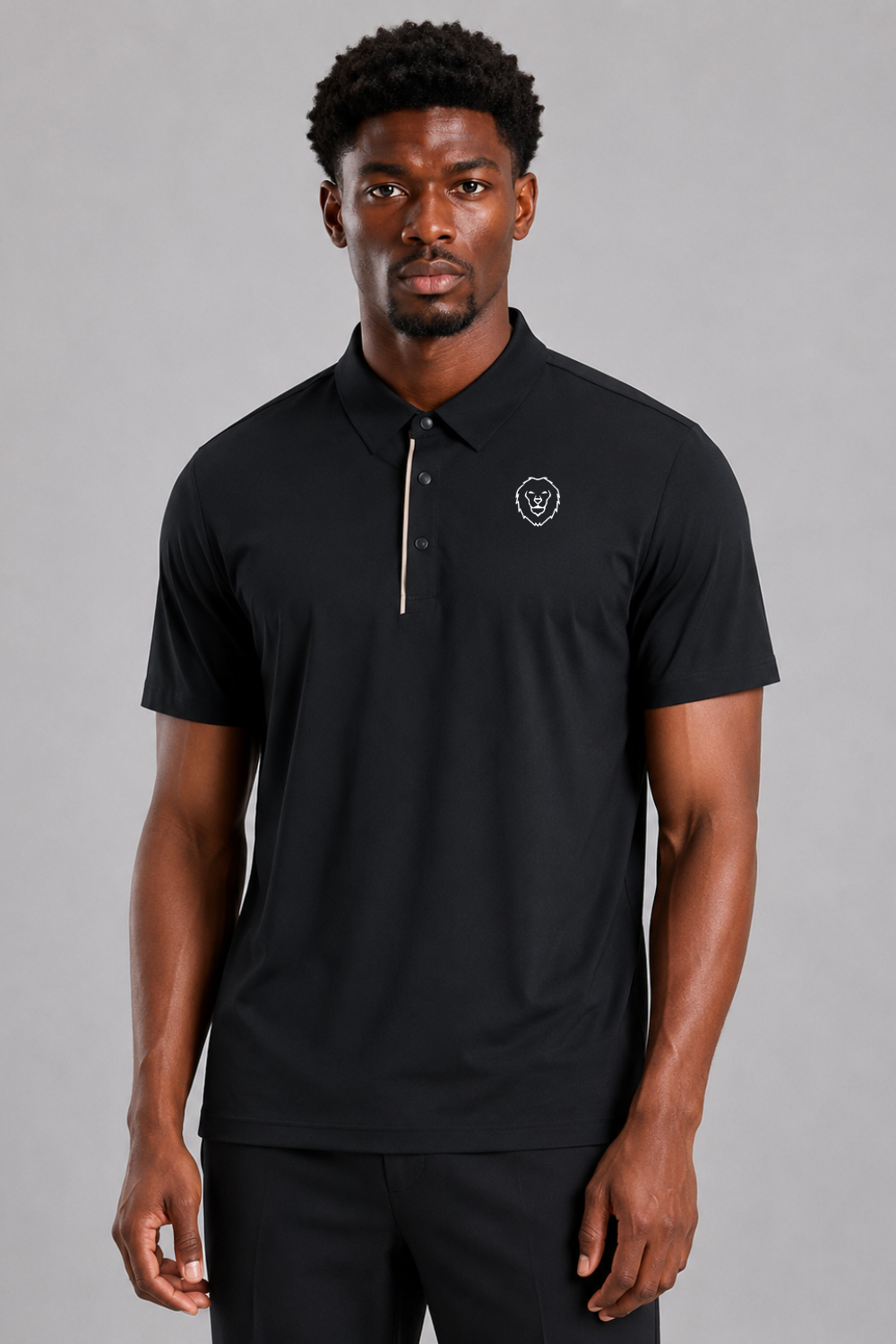 Man wearing a black polo shirt and black pants on a gray background