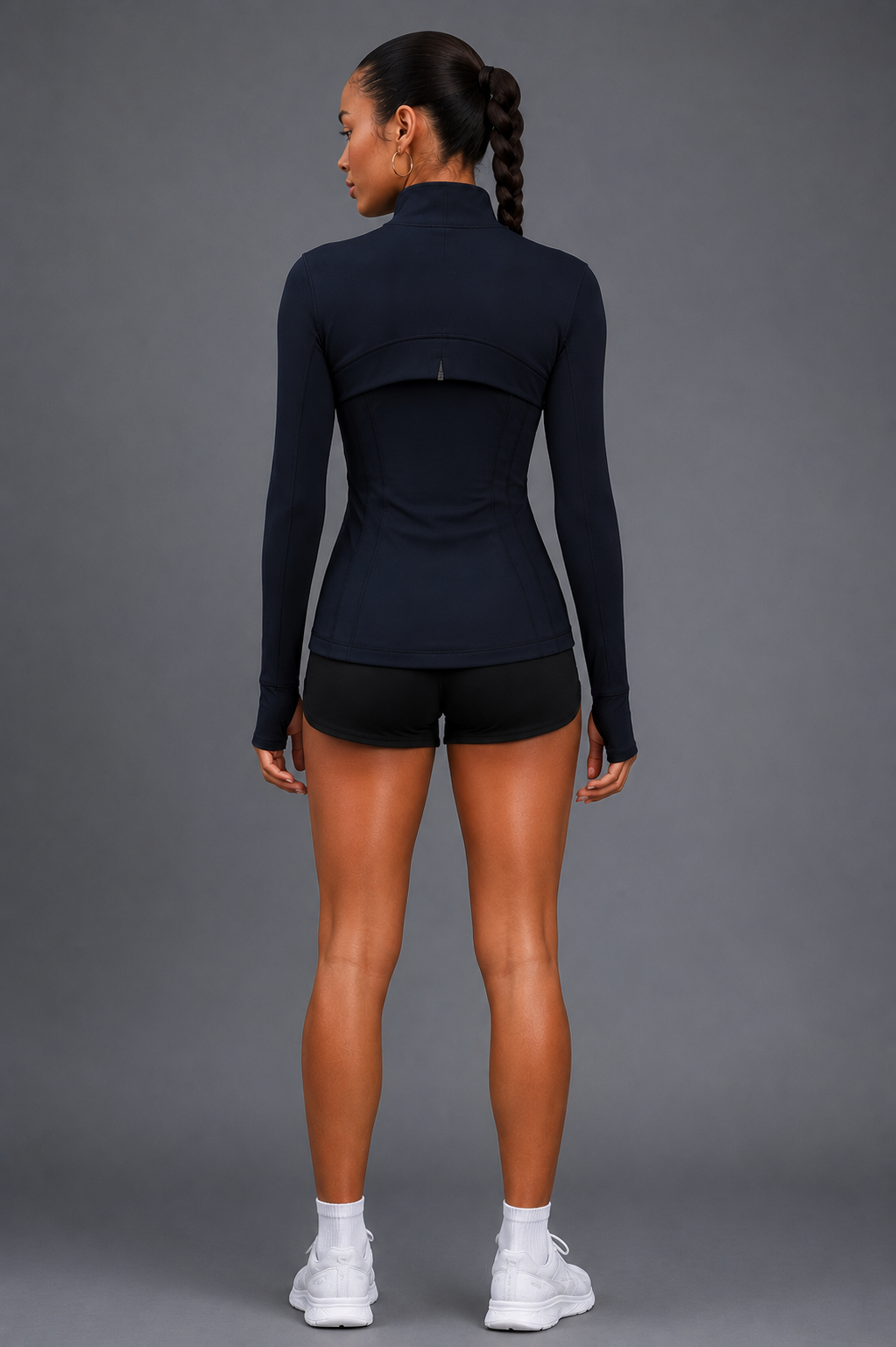 Person wearing a black athletic outfit on a gray background