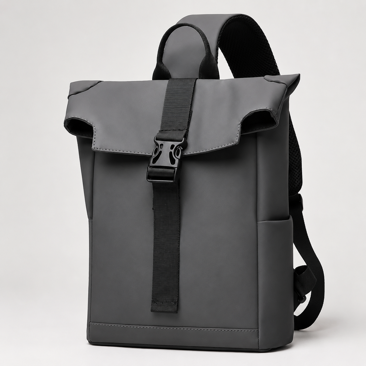 A dark gray backpack with a roll-top flap, black adjustable shoulder straps, and a vertical black strap with a black plastic buckle closure, shown on a light gray background.