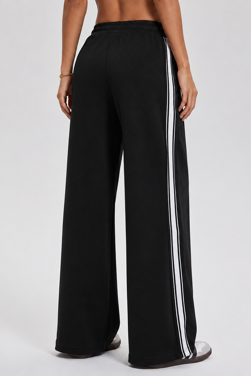 Black wide-leg pants with white stripes on a gray background
