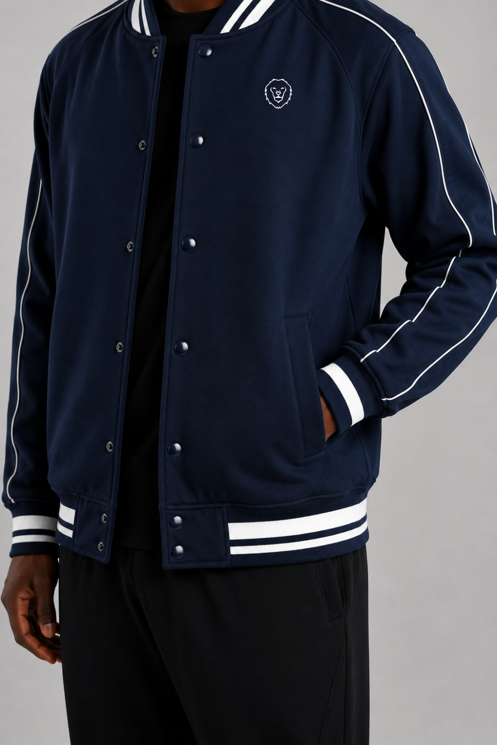 Navy blue varsity jacket with white accents on a gray background