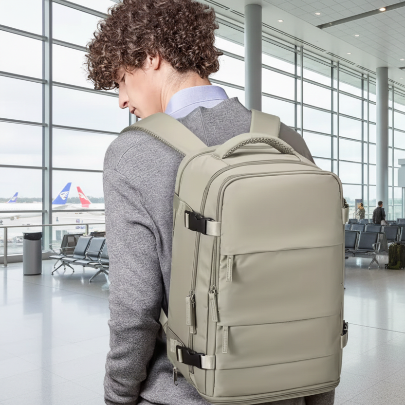 Person wearing a beige backpack with a plain background