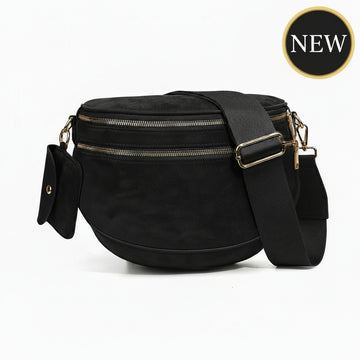 Black crossbody bag with gold zippers on a white background