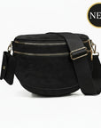 Black crossbody bag with gold zippers on a white background