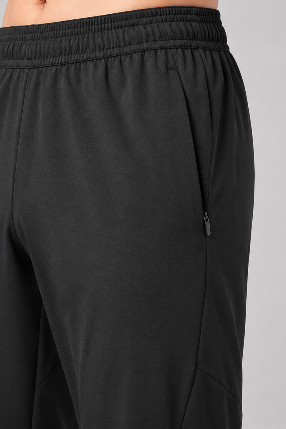 Black athletic pants on a gray background