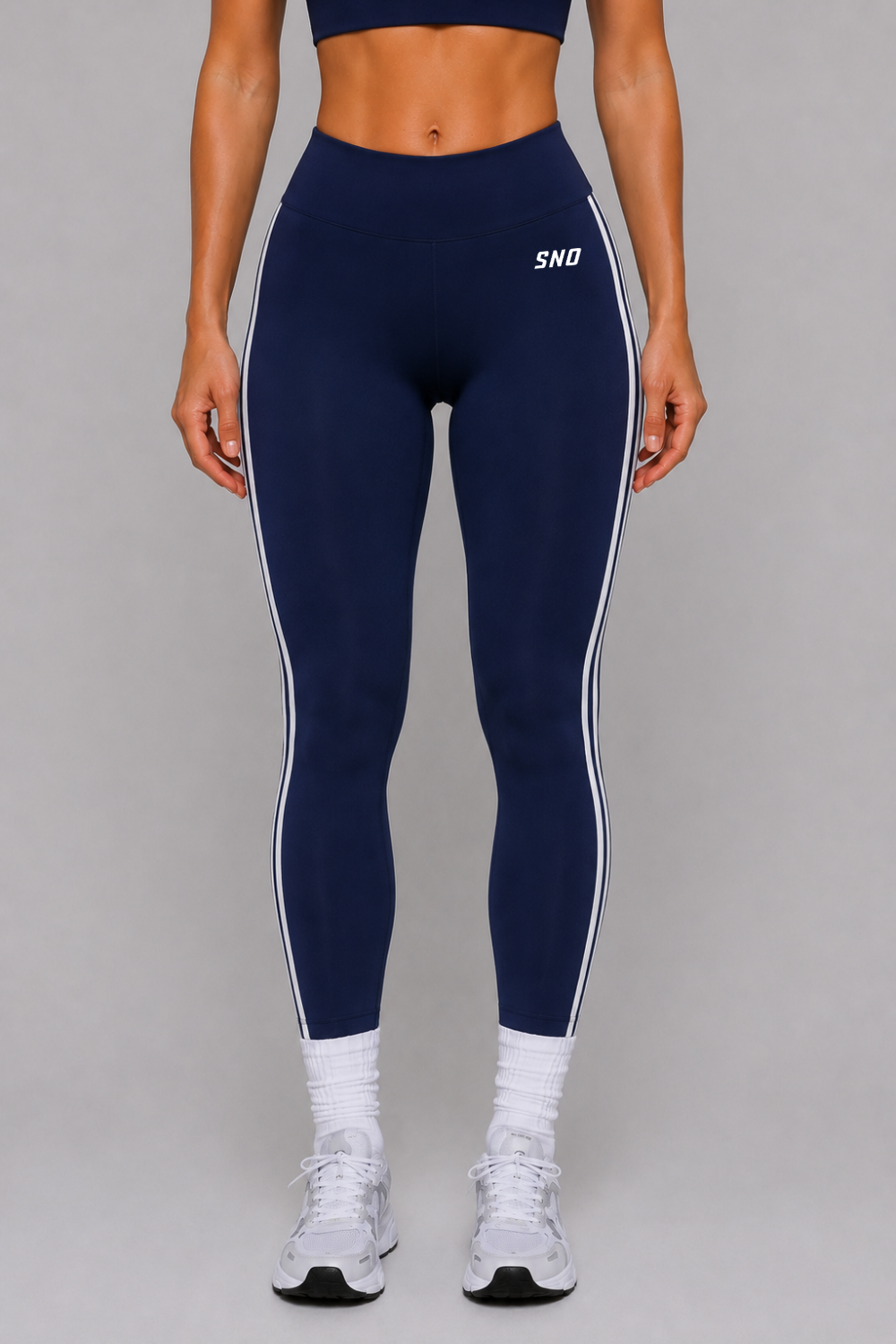 Navy leggings with white stripes and 'SNO' branding on a gray background