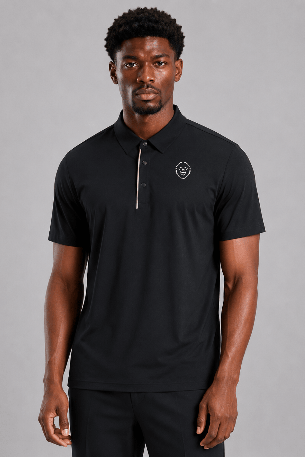 Man wearing a black polo shirt and black pants on a gray background