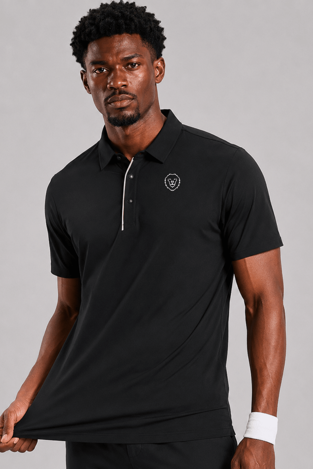 Man wearing a black polo shirt and black pants on a gray background